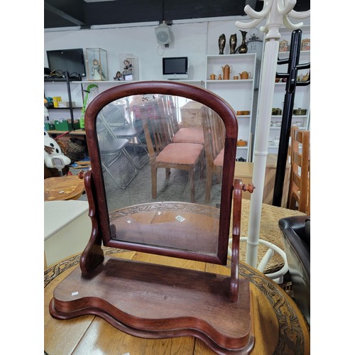 472 - An antique mahogany dressing table mirror with sepentine front ware to the top of the mirror stands ... 