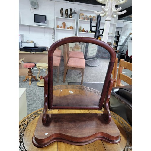 472 - An antique mahogany dressing table mirror with sepentine front ware to the top of the mirror stands ... 