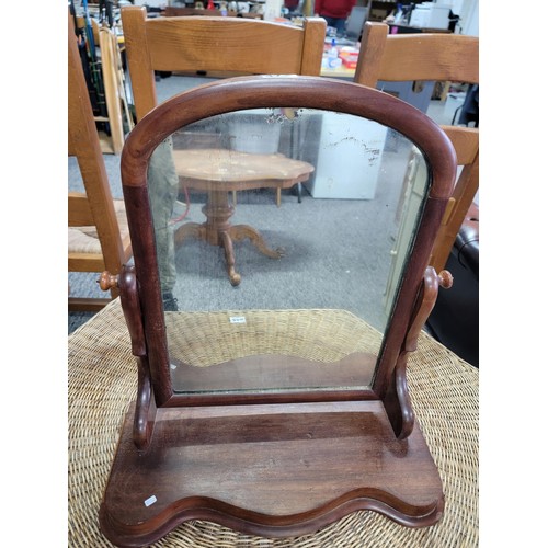 472 - An antique mahogany dressing table mirror with sepentine front ware to the top of the mirror stands ... 