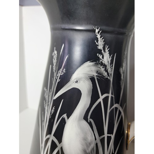 153 - Pair of large Lawleys black and white egret decorated jugs, both jugs have gilding to the handles, o... 