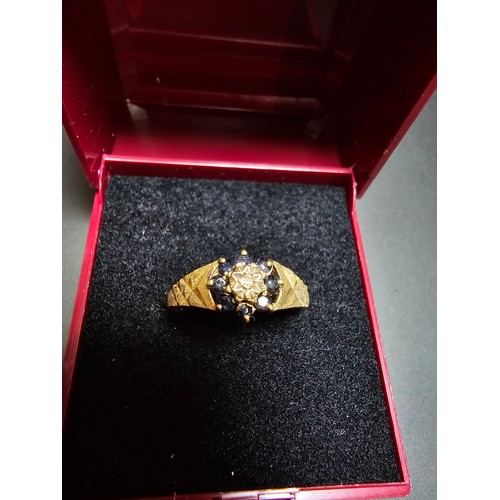 202 - A gold plate on solid 925 silver hallmarked ring inset with 8 sapphire stones and a diamond to the c... 