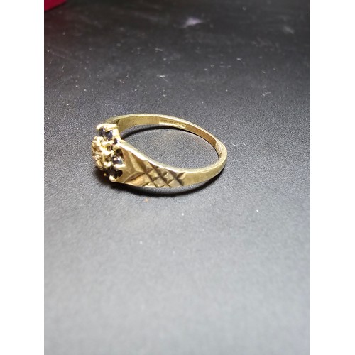 202 - A gold plate on solid 925 silver hallmarked ring inset with 8 sapphire stones and a diamond to the c... 