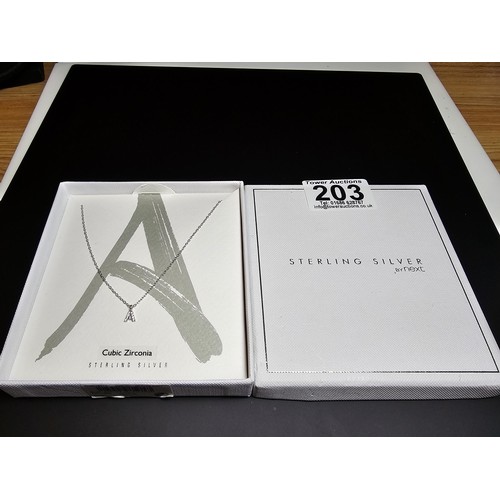 203 - An as new boxed sterling silver necklace with a letter 