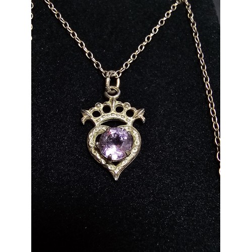 207 - A pretty vintage 925 silver pendant inset with an amethyst, set on an 18