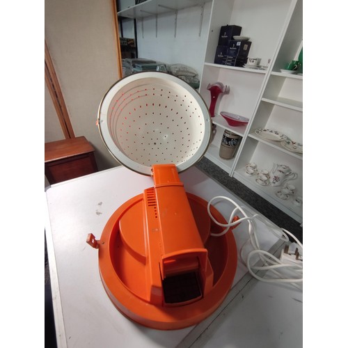 354 - A retro 1960's/70's orange calor 750w portable hair dryer, made in France. Stands at 29cm closed.