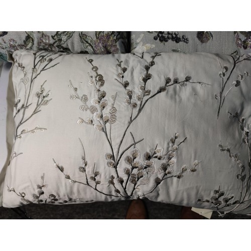 363 - A pair of Laura Ashley Kaylee embroidered scatter cushions in pale duck egg depicting a floral desig... 