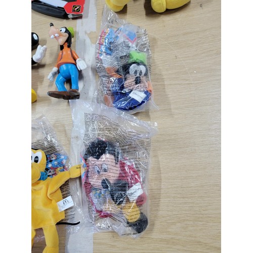 60 - Large collection of Disney related items to include a large pair of mickey mouse gloves, Mickey Mous... 