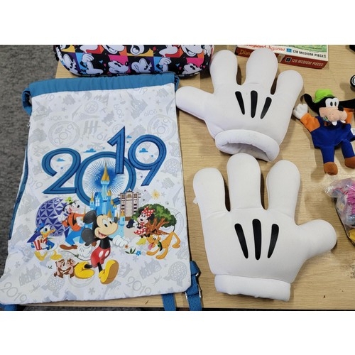 60 - Large collection of Disney related items to include a large pair of mickey mouse gloves, Mickey Mous... 