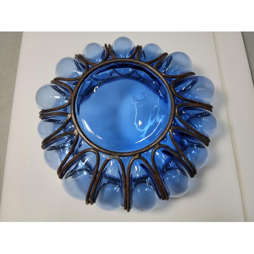 282 - A hand blown Murano blue glass bowl encased in a metal cage, in excellent condition. Height of 9cm, ... 