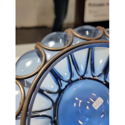 282 - A hand blown Murano blue glass bowl encased in a metal cage, in excellent condition. Height of 9cm, ... 