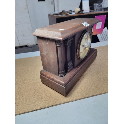 286 - A good quality Ansonia oak mantel clock by Waterbury striking on a bell and coil gong complete with ... 