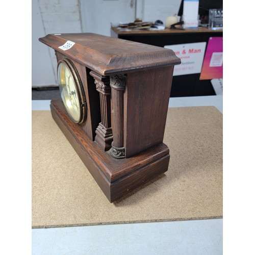 286 - A good quality Ansonia oak mantel clock by Waterbury striking on a bell and coil gong complete with ... 