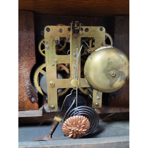 286 - A good quality Ansonia oak mantel clock by Waterbury striking on a bell and coil gong complete with ... 