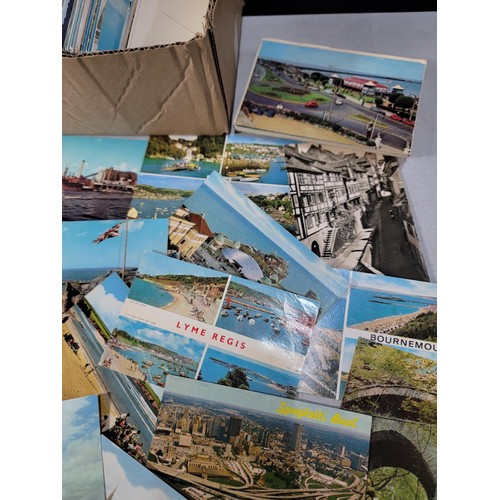 287 - A small box containing a very large quantity of various postcards including postcards from locations... 