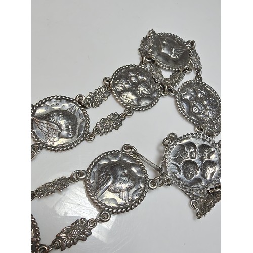 158 - Fine quality hallmarked silver 11 panel link belt with 2x buckle ends featuring ornate embossed scen... 