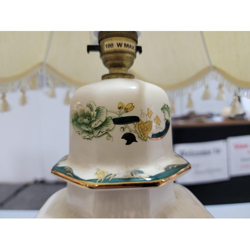 291 - A large Masons ceramic Chartreuse Lamp with gilding to the edges, standing on a wooden plinth and co... 