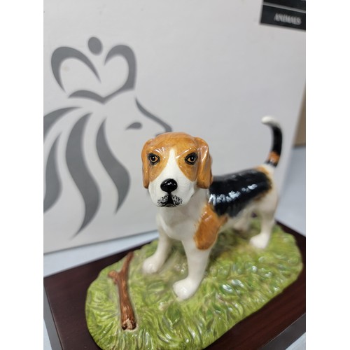 292 - A boxed Royal Doulton Beagle figure RDA 11, hand decorated figurine, standing on a wooden plinth, ha... 