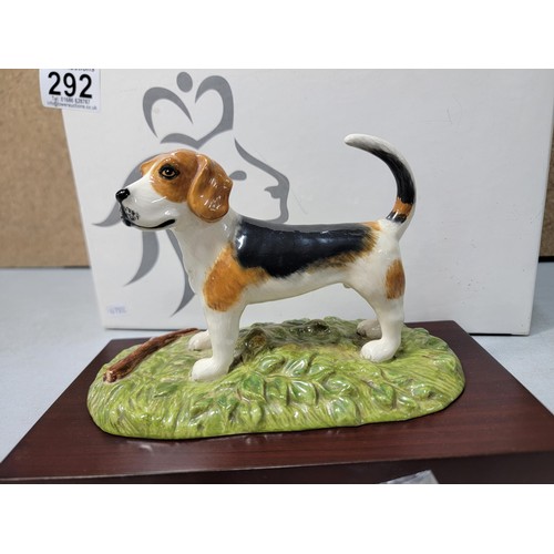 292 - A boxed Royal Doulton Beagle figure RDA 11, hand decorated figurine, standing on a wooden plinth, ha... 