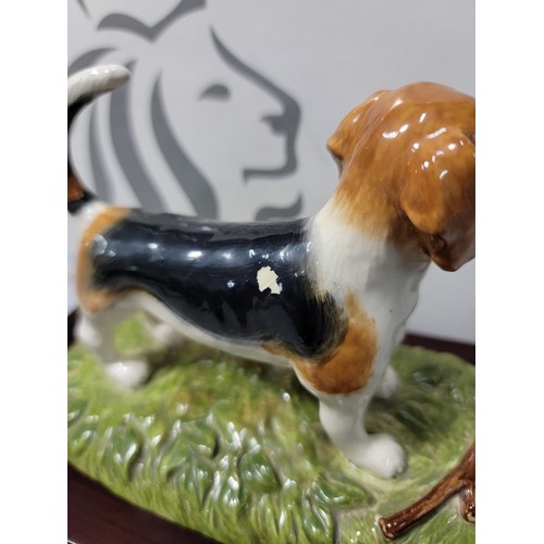 292 - A boxed Royal Doulton Beagle figure RDA 11, hand decorated figurine, standing on a wooden plinth, ha... 