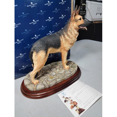 293 - A boxed border fine arts studio large Alsatian figure in excellent condition, standing on a wooden p... 