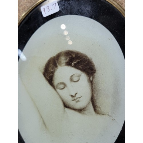 305 - An antique brass framed lithograph of a recumbent lady in excellent condition. Height of 6.5cm, widt... 