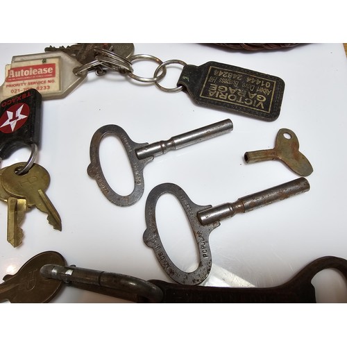 170 - Basket full of various keys to include a squire 660 padlock with its locking key, 2x clock keys alon... 