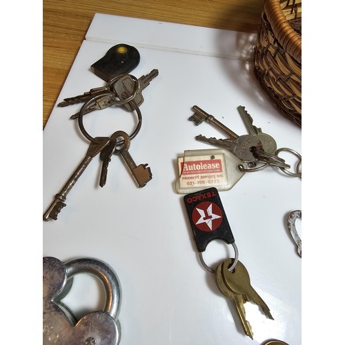 170 - Basket full of various keys to include a squire 660 padlock with its locking key, 2x clock keys alon... 