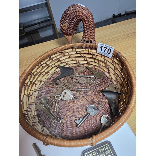 170 - Basket full of various keys to include a squire 660 padlock with its locking key, 2x clock keys alon... 