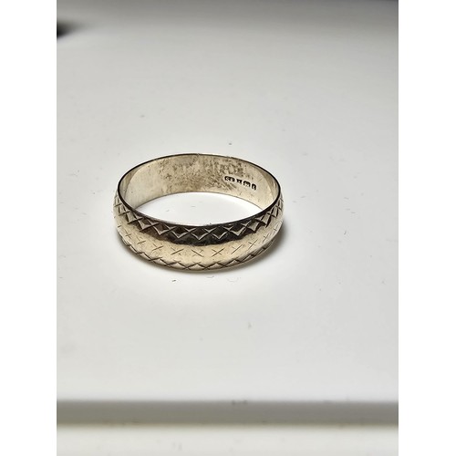 179 - Hallmarked Silver ring with an engraved design - size O in clean condition - boxed.