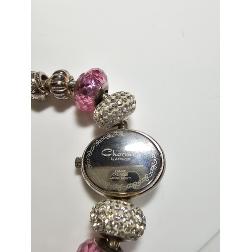 190 - a Charmed by Accurist ladies wrist watch having a Mother of Pearl dial and a jewelled charm bracelet... 