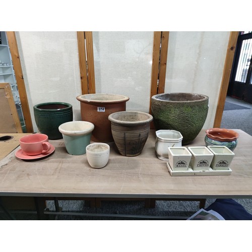 374 - A collection of terracotta plant pots including a 3 graduated set along with a kitchen garden 3 pot ... 