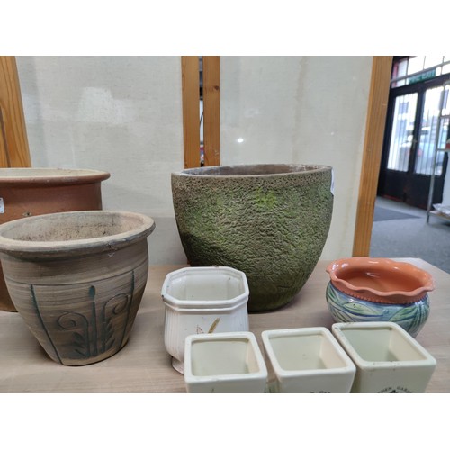 374 - A collection of terracotta plant pots including a 3 graduated set along with a kitchen garden 3 pot ... 