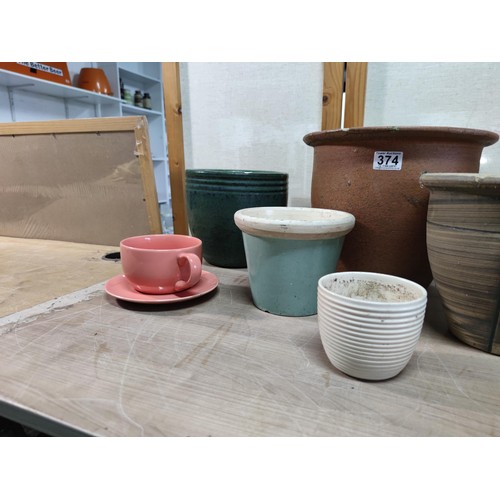 374 - A collection of terracotta plant pots including a 3 graduated set along with a kitchen garden 3 pot ... 