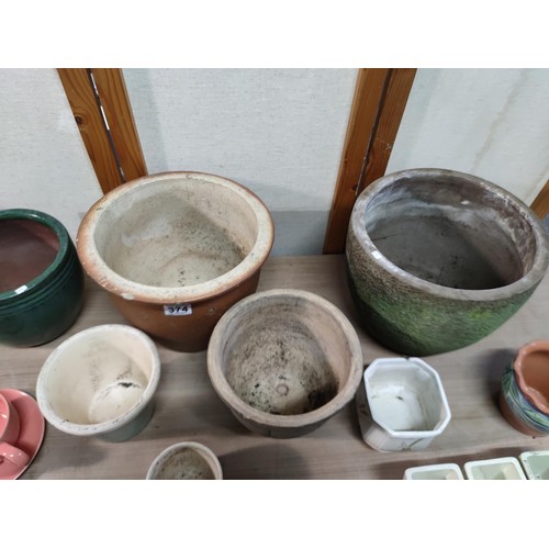 374 - A collection of terracotta plant pots including a 3 graduated set along with a kitchen garden 3 pot ... 