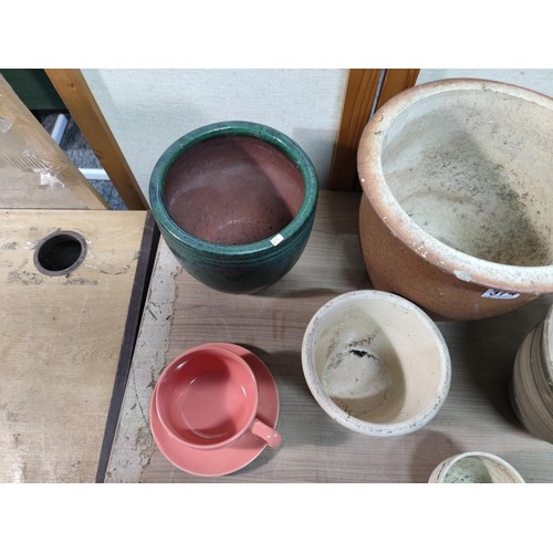 374 - A collection of terracotta plant pots including a 3 graduated set along with a kitchen garden 3 pot ... 