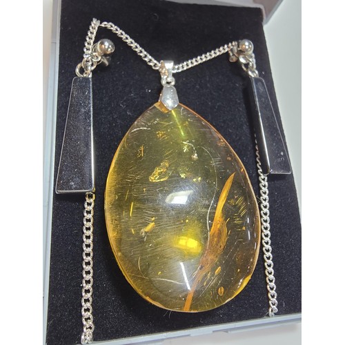 209 - Large and impressive natural baltic amber pendant on a good 18 inch 925 Silver chain along with a pa... 