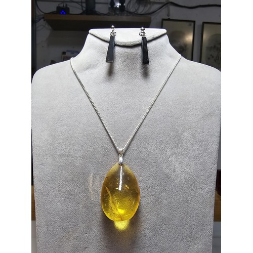 209 - Large and impressive natural baltic amber pendant on a good 18 inch 925 Silver chain along with a pa... 