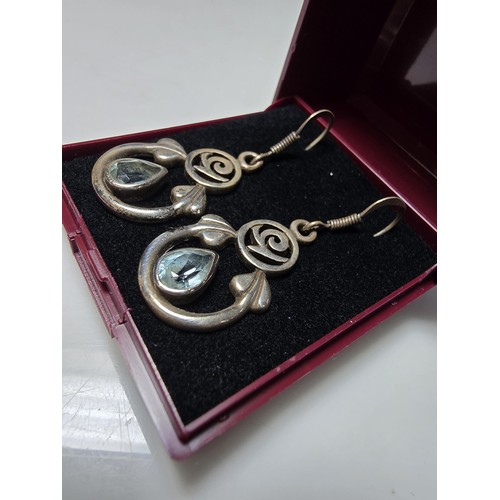 212 - Pair of ornate 925 Silver drop earrings inset with blue topaz stones in the Charles Rennie Mackintos... 