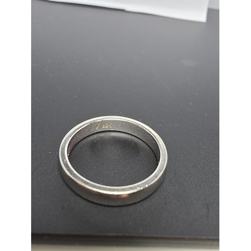 214 - 925 Silver plain band ring - Size K in clean condition - boxed.