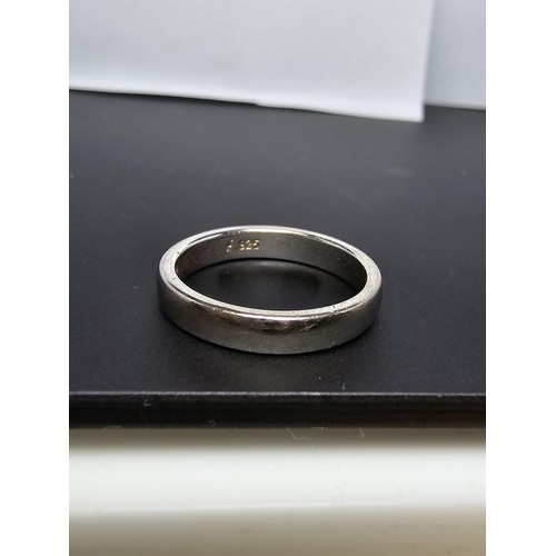 214 - 925 Silver plain band ring - Size K in clean condition - boxed.