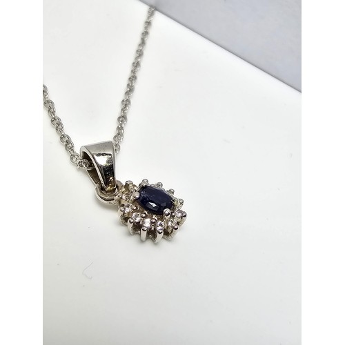 217 - Vintage 925 Silver pendant inset with a blue sapphire gem stone surrounded by clear Topaz stones on ... 