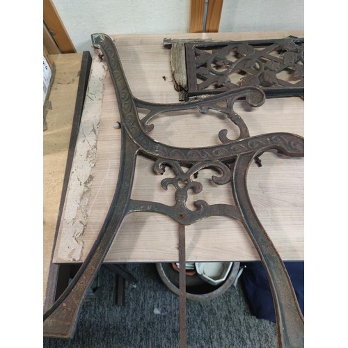 384 - Pair of cast iron bench ends and back support with leaf design height of 75cm