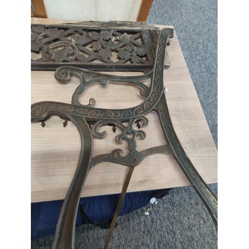 384 - Pair of cast iron bench ends and back support with leaf design height of 75cm