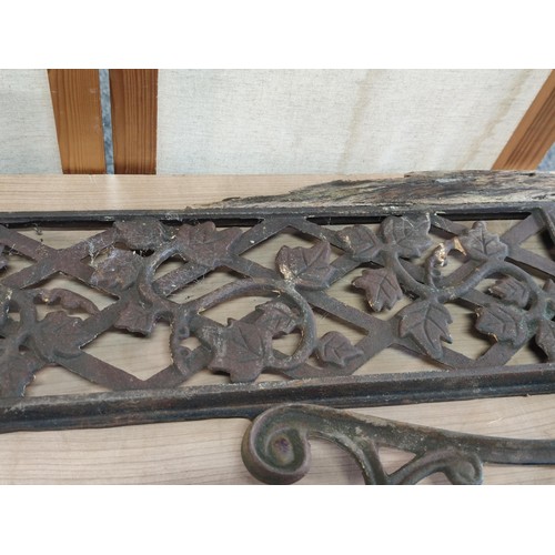 384 - Pair of cast iron bench ends and back support with leaf design height of 75cm