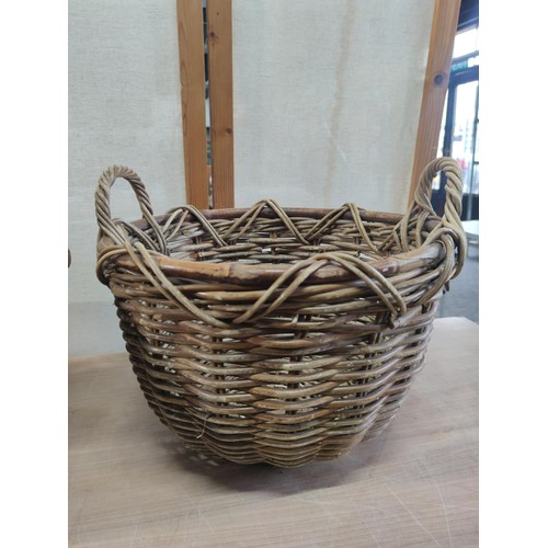 386 - 2x large wicker log baskets with carry handles in good order largest measures 30cm high by 44cm diam... 