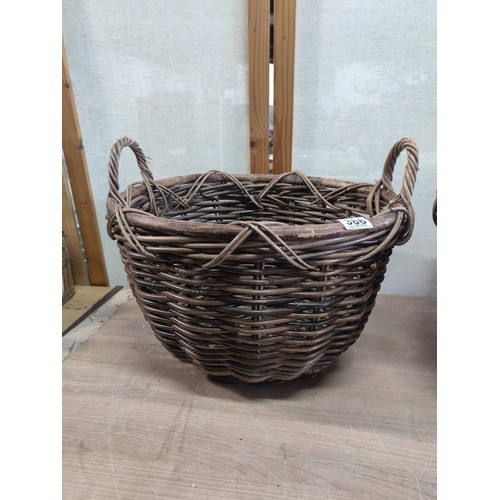 386 - 2x large wicker log baskets with carry handles in good order largest measures 30cm high by 44cm diam... 