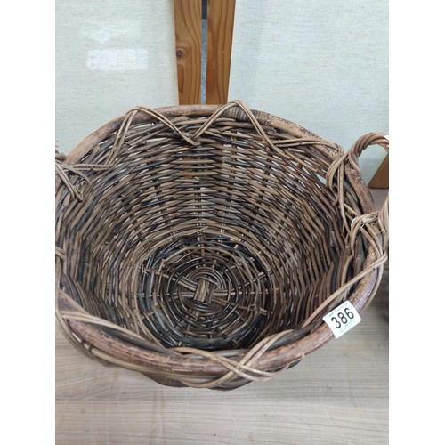 386 - 2x large wicker log baskets with carry handles in good order largest measures 30cm high by 44cm diam... 