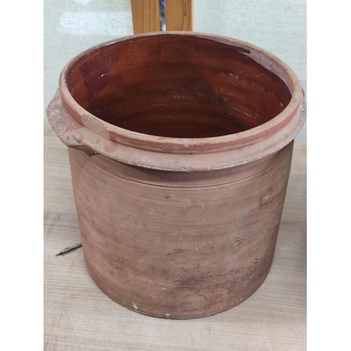 390 - 2x antique terracotta dairy mixing bowls both with glazed interiors, largest bowl measures 24cm high... 