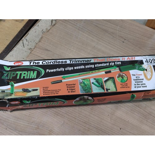 409 - A boxed cordless Ziptrim cordless trimmer for grass cutting, etc. Battery operated.