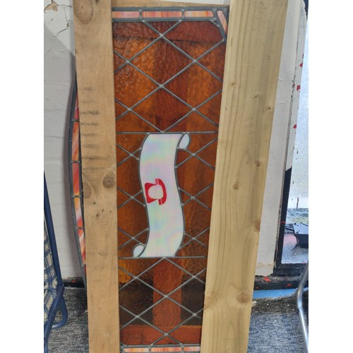 435A - A stained glass advertising telephone number window sign with amber coloured glass inset with mother... 